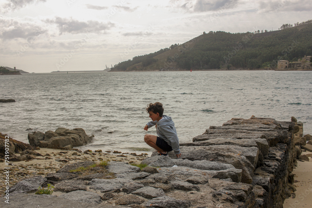 a curious boy exploring a beach a curious boy exploring a beach