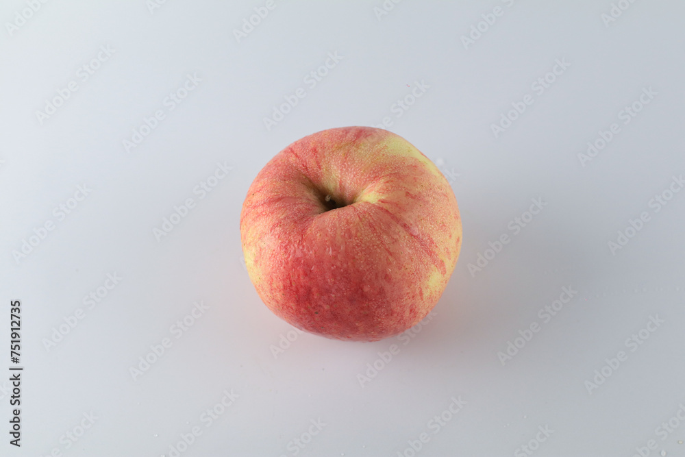 Red apple on white background. Tropical fruit abstract background. Copy space for design or text. Red apple on white background. Tropical fruit abstract background. Copy space for design or text.