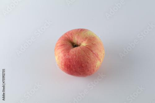 Red apple on white background. Tropical fruit abstract background. Copy space for design or text.