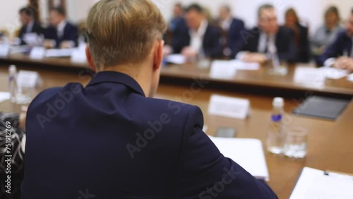 Group of men in business suits talking and discussing at conference, politicians and entrepreneurs debate, networking and negotiate, businessmen have dialog conversation on a forum, panel discussion