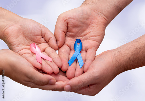 Foto Two hands holding two Pink and Blue ribbons for the Pink October and Blue November campaigns to support life and raise awareness about cancer