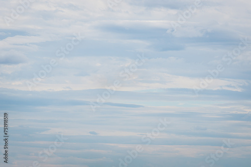 Calm skies with soft streaks of clouds that look like watercolor strokes on a canvas. Subtle shades of blue and gray create an atmosphere of peace and relaxation