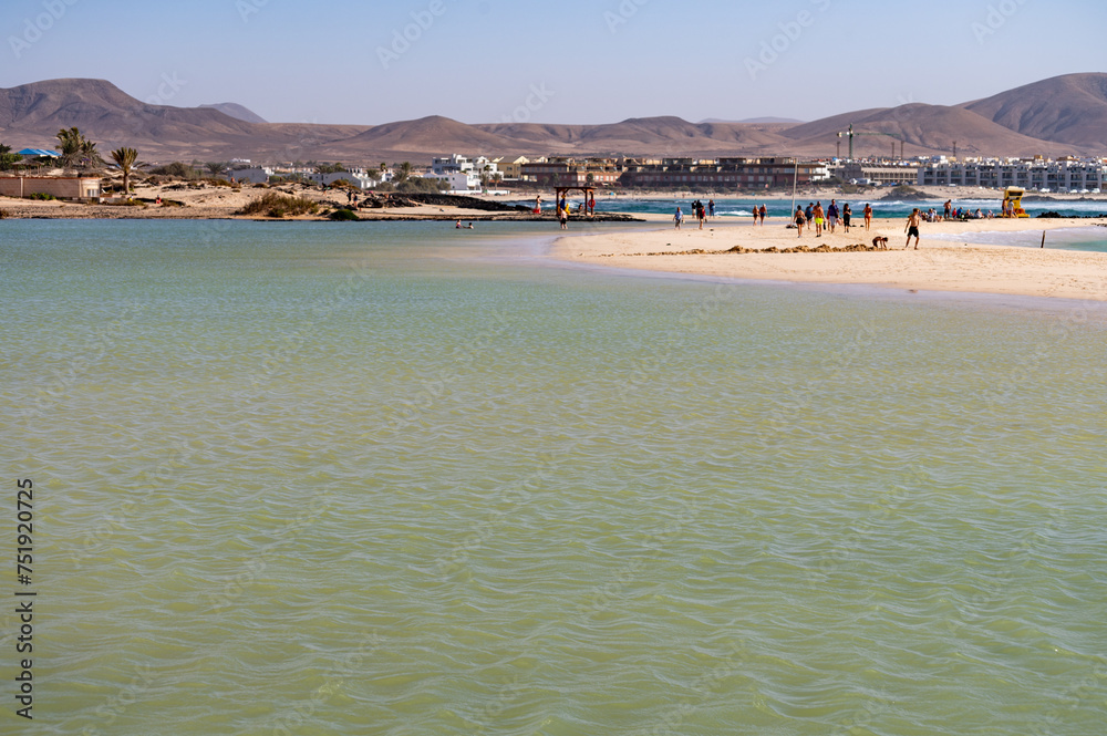 Obraz premium West coast of Fuerteventura island. Winter sea and sun vacation in El Cotillo touristic village, Canary islands, Spain. White sandy beach La Concha..