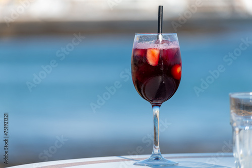 Glass of cold sangria wine served with orange in beach cafe, Corralejo, Fuerteventura, Spain