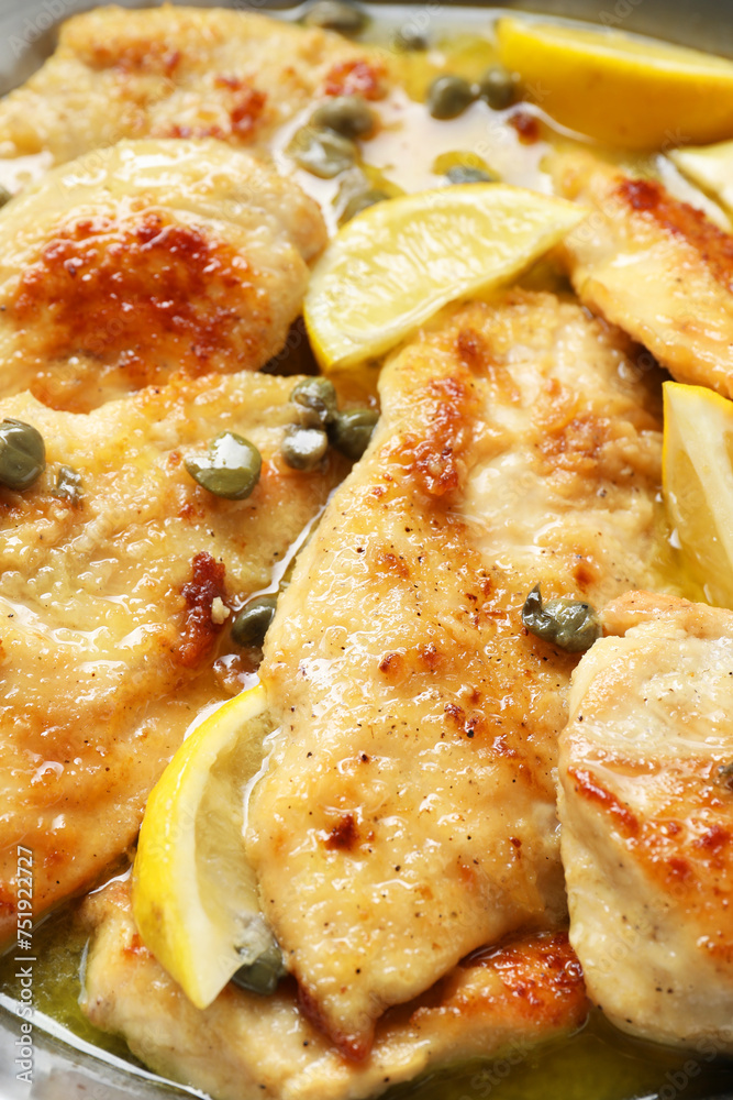 Delicious chicken piccata with lemons in pot, closeup Delicious chicken piccata with lemons in pot, closeup