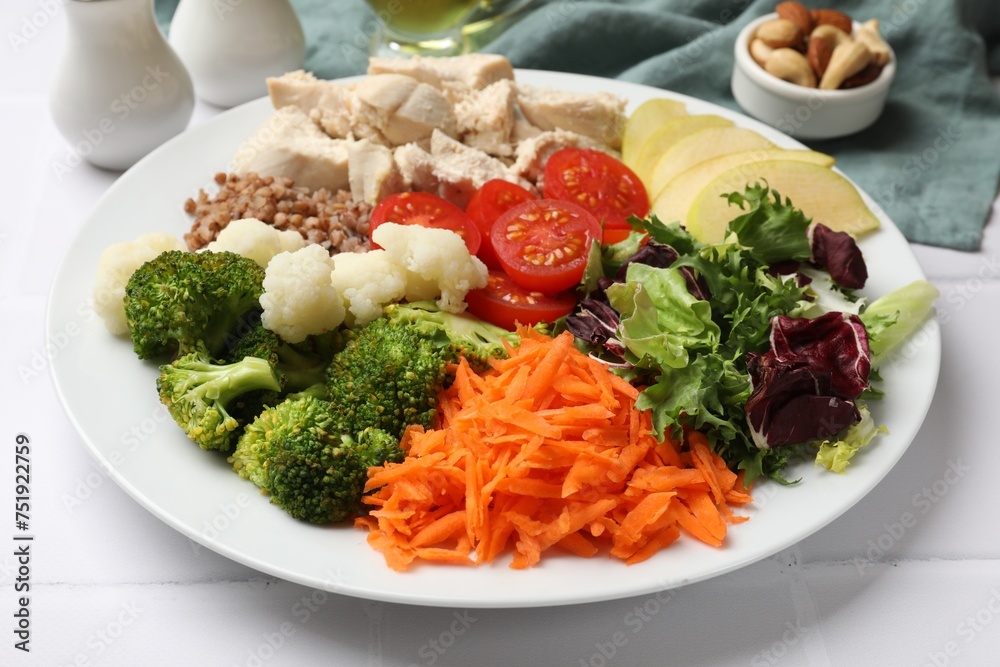 Balanced diet and healthy foods. Plate with different delicious products on white tiled table, closeup Balanced diet and healthy foods. Plate with different delicious products on white tiled table, closeup