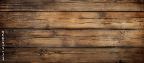 A close-up view of a wooden wall with a rich brown background. The wall is made up of individual wooden planks that create a textured pattern. The brown color is warm and earthy, adding a sense of