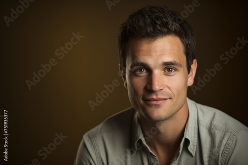 Portrait of a handsome young man smiling at the camera over dark background