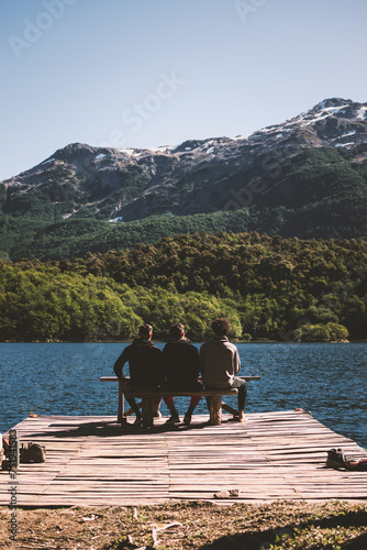 Varones jóvenes exploran la majestuosidad de las montañas patagónicas, acompañados de lagos serenos y cascadas en un paisaje de asombrosa belleza natural