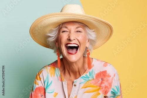 Portrait of a happy senior woman with hat screaming on colorful background