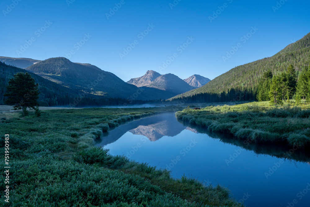 Rocky Mountain meadow with river reflection in Utah