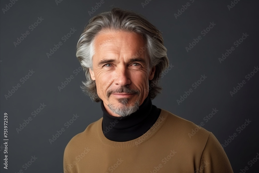 Portrait of a handsome mature man on grey background. Men's beauty, fashion.