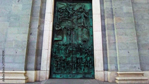 huge metallic bronze church door of Catedral De La Almudena in Madrid photo