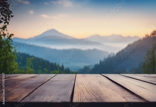 Wooden platform with scenic view of mountains during sunrise.