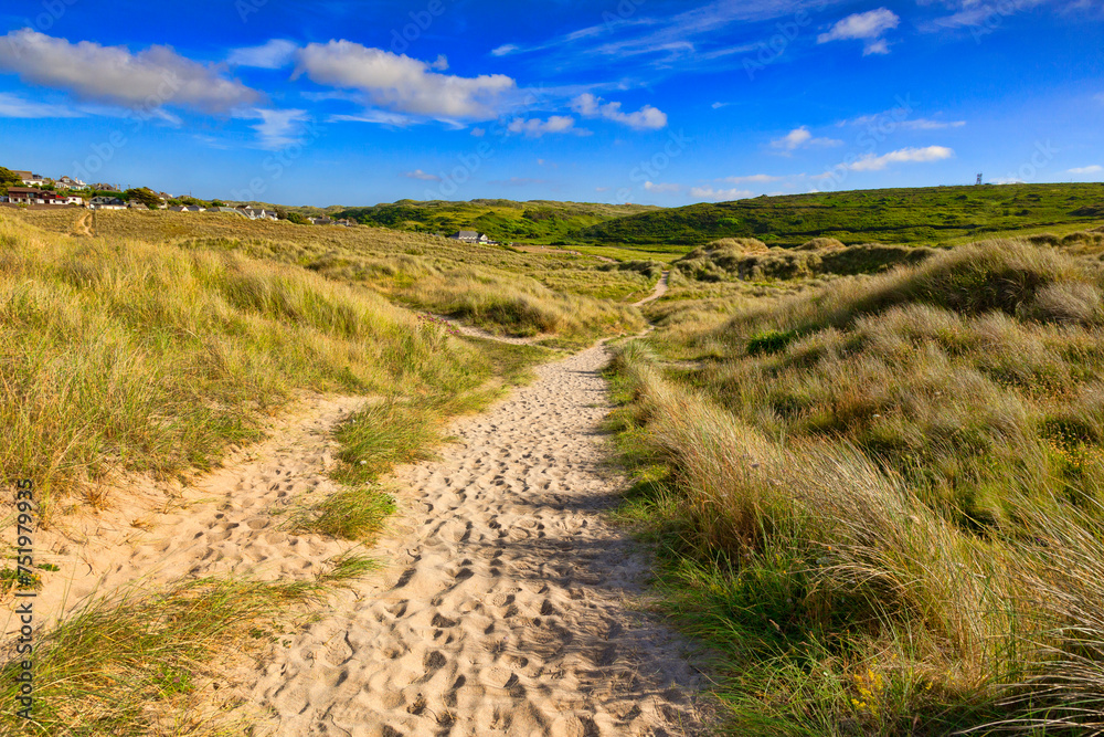 Sandy path - the South West Coast Path passes through sand dunes near Holywell Bay, Cornwall, UK.
