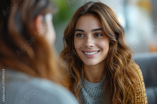 Conversation, interview, appointment with a psychologist concept. Portrait of a positive young woman listening to her interlocutor photo