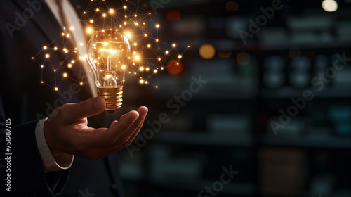 Businessman hand holding creative light bulb with industry network,analysis solution and development marketing network icons planning strategy, Modern business, Innovative of new ideas.