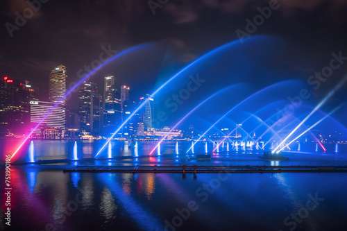 Night view of Singapore city sky with laser light