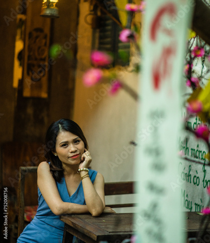 Woman wearing trendy clothes, well-proportioned figure of 35 years old, beautiful colors in Sai Gon's Tet season