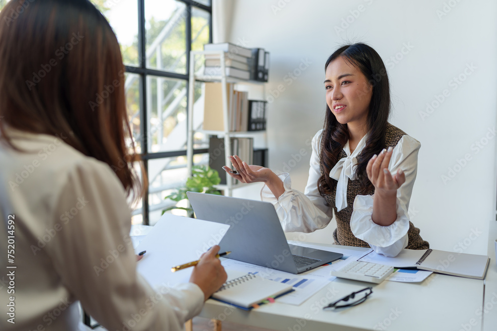 Analysis, Discussion, Asian women economists and marketers use a tablet computers to plan investments and finances to prevent risks and losses for the company, Negotiation