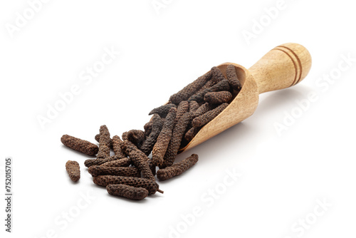 Front view of a wooden scoop filled with Organic Long pepper (Piper longum) fruit. Isolated on a white background. photo