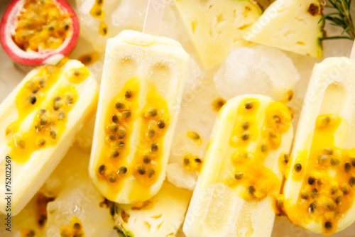Pineapple popsicles with fresh passion fruit in ice tray.