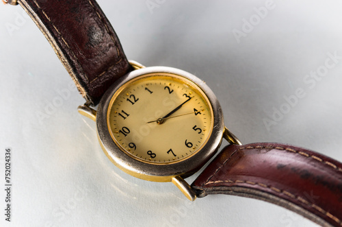 Old wristwatch close-up on a white background