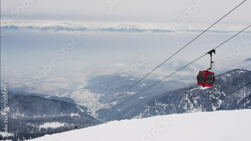 Gondola Cable Car Moving Uphill On Snowy Apharwat Summit In Gulmarg, India. high angle, static shot photo