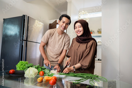 Portrait of a Muslim couple preparing food together