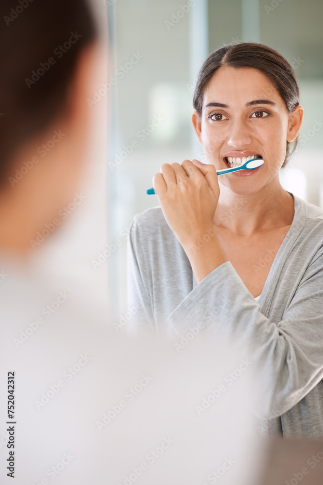 Woman, brushing teeth and smile in home by mirror for health, wellness or self care for breath in morning. Girl, person and happy with toothbrush, mouth and cleaning for hygiene at apartment in Chile Woman, brushing teeth and smile in home by mirror for health, wellness or self care for breath in morning. Girl, person and happy with toothbrush, mouth and cleaning for hygiene at apartment in Chile