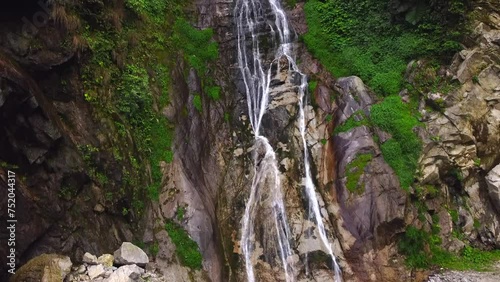 Nichiphula waterfall flow into the kameng river in a deep valley surrounded by mountains of the himalayas near Dedza, arunachal pradesh, India. photo