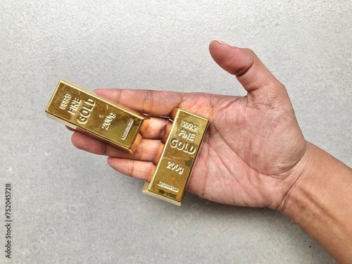 Palm Hand holding Gold Bars