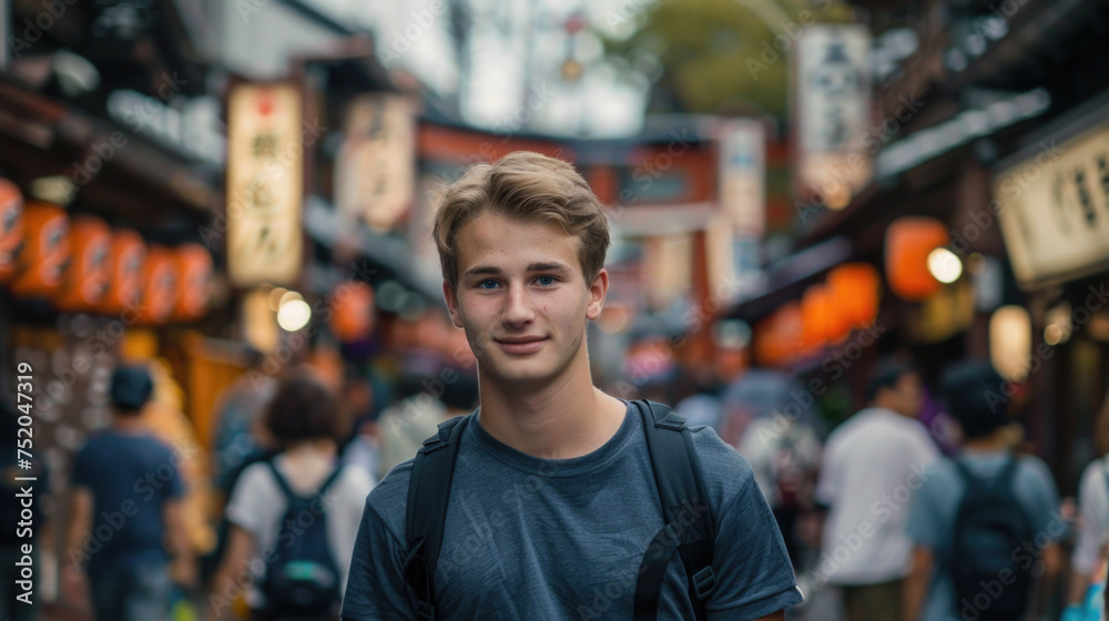 Young smiling male traveler standing in a crowded Japanese town Young smiling male traveler standing in a crowded Japanese town