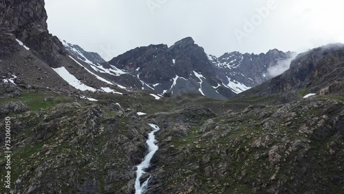Mountain waterfall flowing through rocky terrain at Cascata di Stroppia near Lago Niera, overcast weather photo