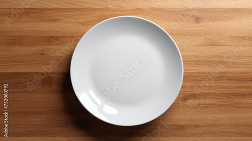 A simple white plate on a rustic wooden table. Perfect for food and kitchen concepts