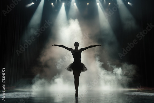 Beautiful young ballerina in tutu dancing on stage with spotlights.