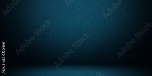 Empty dark concrete wall room studio background and floor perspective with blue soft light well editing displays product and text present on free space cement backdrop photo