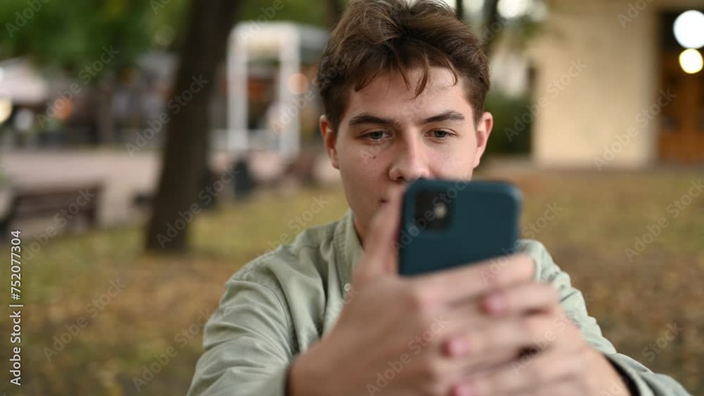 The guy is enthusiastically photographing something on his phone. Close-up The guy is enthusiastically photographing something on his phone. Close-up