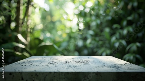 Detailed view of a textured concrete table with a blurred forest background