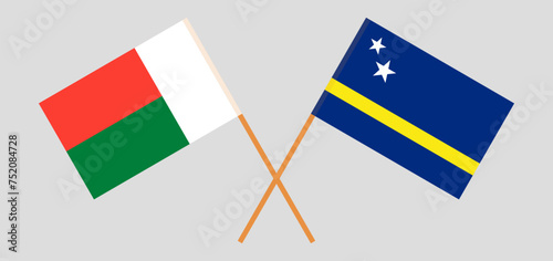 Crossed flags of Madagascar and Country of Curacao. Official colors. Correct proportion