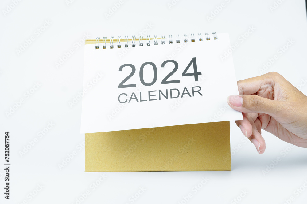 woman hand open 2024 calendar on white background woman hand open 2024 calendar on white background