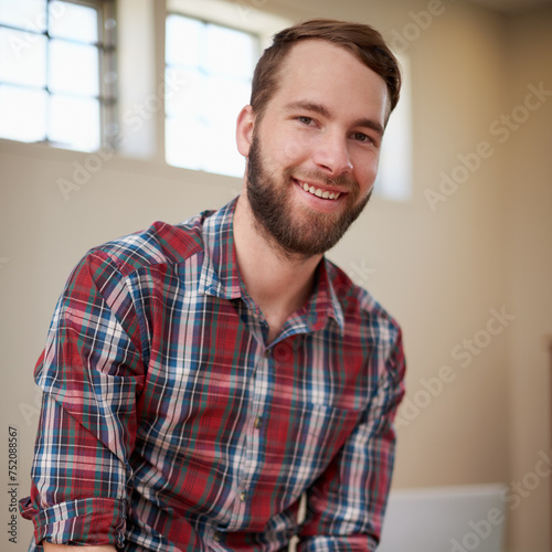Portrait, smile and man in workplace, architecture and career in construction industry on break. Male person, contractor and entrepreneur of startup, small business and relax on desk of office