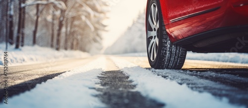Red Car Cruising Along Snow...