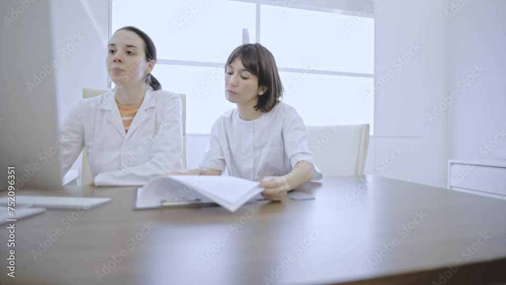 slow motion video of two young female doctors working together slow motion video of two young female doctors working together