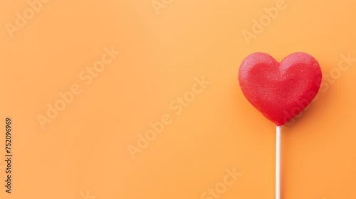 Heart shaped tasty red lolly  with copy space. © Nikolay