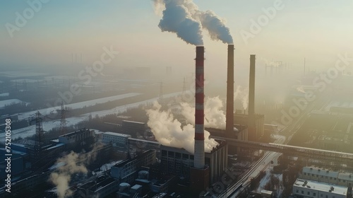 Industrial power plant with thick CO2 smoke from chimney. Concept of Global warming cause and urban environment problem from factories. Aerial view of smokestack with smoking chimneys.