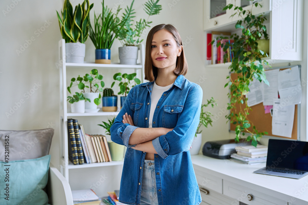 Portrait of young confident smiling woman in home interior Portrait of young confident smiling woman in home interior