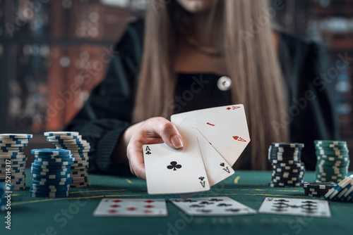 Woman before winning at poker game with two aces in hand at gaming table