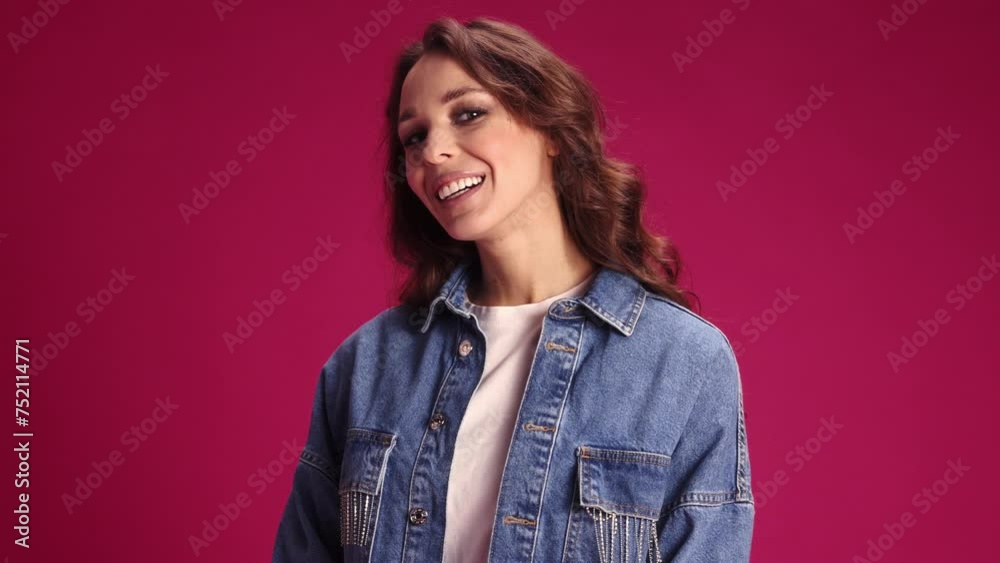 Beautiful, elegant young woman with nude makeup, curly hair posing with smile, laughing against pink studio background. Happiness. Concept of youth, lifestyle, casual fashion, human emotions Beautiful, elegant young woman with nude makeup, curly hair posing with smile, laughing against pink studio background. Happiness. Concept of youth, lifestyle, casual fashion, human emotions
