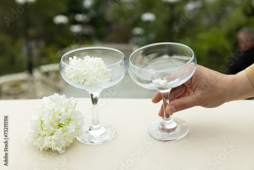 Two glass glasses with flowers on the background of the sea. photo